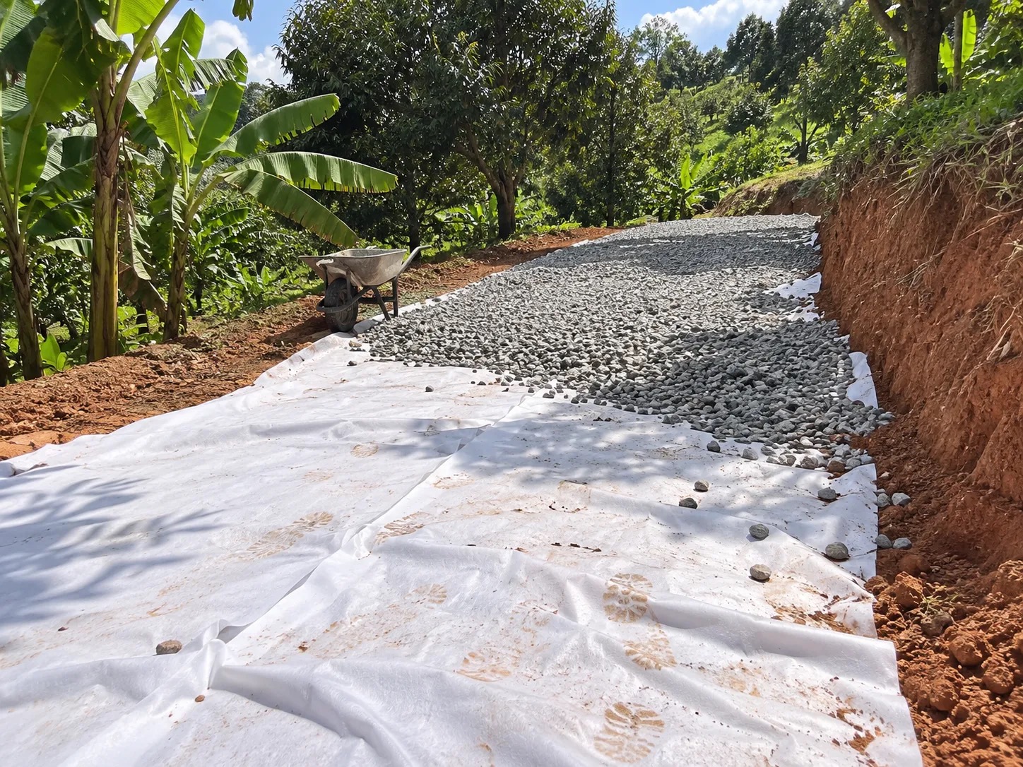 AeroTex non-woven geotextile laid under crushed stone on a farm road